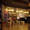Stylish Bar Interior Featuring Neon Sign Bar Counter Hanging Lights And Wine Racks