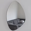Oval Mirror with Lighted Edge Reflecting Gray Sofa and Pillows in White Wall Interior