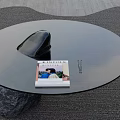 Modern Round Glass Coffee Table Featuring Black Stone Base Kinfolk Magazine And Pen