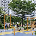 Outdoor Children's Play Area With Playground Equipment Green Trees And Parental Strollers