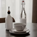 White Condiment Bottle Glass Water Bottle Ceramic Cup And Saucer On Table