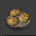 Three Seeded Bread Rolls on Silver Plate Against Dark Blue Background