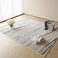 Light Gray Striped Square Rug on Wooden Floor with White Flower Vase and Magazine