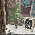 Elegant Bonsai Potted Plant on White Table with Patterned Wallpaper and Decorative Picture Frame