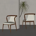 Two Modern Dining Chairs With Wooden Frame And Beige Seat Cushions By Palm Plant