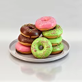 Colorful Frosted Donuts with Pink Green Brown Sprinkles on White Plate Light Background