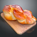Golden Brown Braided Bread On Wooden Cutting Board With Glossy Finish