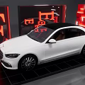 White Sedan Showcased In Modern Exhibition Space With Red Illumination