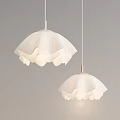 White Pendant Lights With Wavy Design Hanging On Neutral Wall Emitting Soft Glow