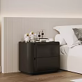 Black Bedside Table With Lamp And Decorative Items Next To White Bed In Modern Bedroom