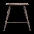 Rustic Wooden Stool With Round Seat And Four Carved Legs Design