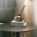 Decorative Ornament Set Featuring Silver Vase Incense Sticks On Books Round Side Table Gray Sofa