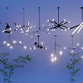 Stylish Modern Pendant Lights With Various Designs And Bulbs On Blue Background With Green Plants