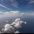 Green Missile Flying With Rocket Exhaust Over Ocean And Land Under Cloudy Sky
