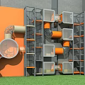 Colorful Modern Playground Equipment With Orange Gray Grid Cages Tubes Platforms And Circular Climbing Features
