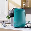 Teal Coffee Maker Kitchen Appliance On Modern Marble Countertop With Cabinets And Window Plant