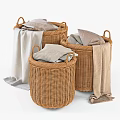 Three Woven Storage Baskets With Folded Clothes And Towels For Home Organization