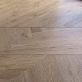 Light Brown Hardwood Flooring With Herringbone Pattern And Natural Texture