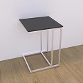 Modern Coffee Table With Black Tabletop And Silver Metal Frame On Wooden Floor