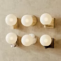 Modern Decorative Wall Sconces With White Spherical Shades And Various Base Colors On Beige Wall