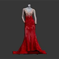 Mannequin Wearing Elegant Red Gradient Gown With Lace Embroidery And Flowing Train Against Dark Background