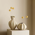 Tall Textured And Short Rounded Beige Vases With Yellow Pom Pom Flowers On Light Table