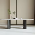 Oval Marble Top Dining Table With Black Legs And Plant In Vase In Minimalist Room
