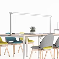 Modern Office Desk Featuring Colorful Chairs Potted Plant And Magazines On Surface