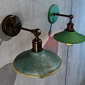 Vintage Industrial Wall Lamps with Green Glass Shades and Brass Arms Mounted on Gray Wall