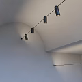 Black Downlights Spotlights Installed On Arched White Ceiling Four In A Line Lighting The Wall