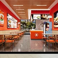Bright Restaurant Interior With Red Orange Walls Wooden Ceiling Food Posters Counter And Orange Chairs