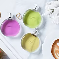 Chanel Perfume Cosmetics Collection with Colorful Bottles White Flowers Coffee and Jewelry