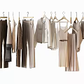 Stylish Hanging Clothes In Neutral Tones Featuring Various Styles Like Pants Shirts And Dresses