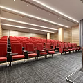 Modern Conference Room with Red Seats Wooden Walls Gray Carpet and Podium