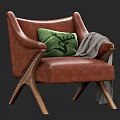 Brown Leather Armchair With Green Deer Pattern Pillow Gray Blanket Wooden Legs And Rivet Accents