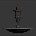Elegant Bronze Candlestick With Lit Candle And Ornate Round Base Design