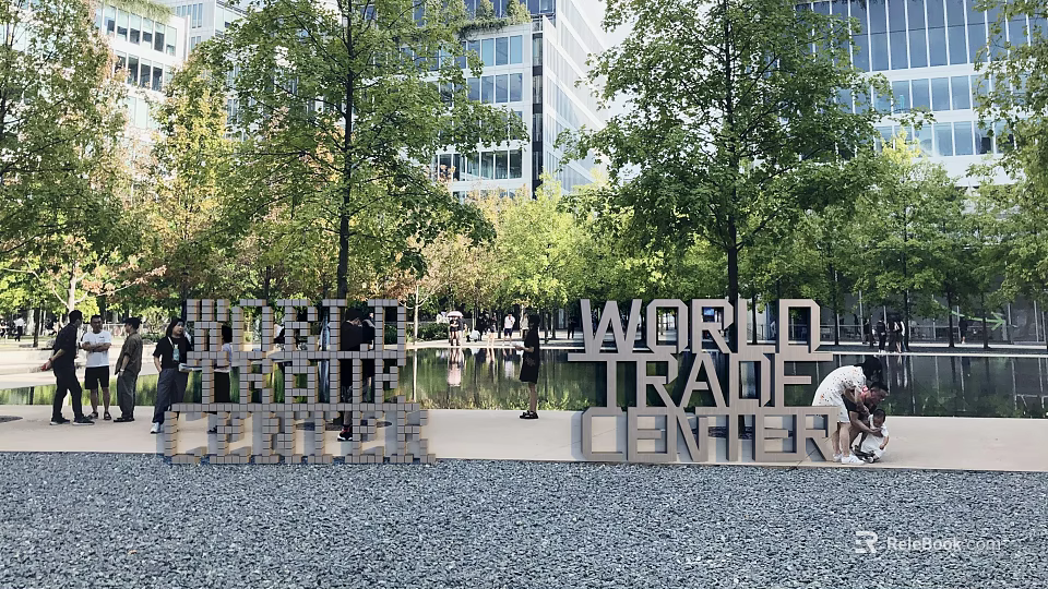 World Trade Center Sculpture in Urban Park with Trees and Visitors Nearby 3d model 