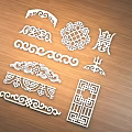 Ornate Wooden Decorative Carvings With Various Traditional Patterns And Shapes On Table