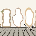 Various Shaped Wooden Mirrors Wall Mounted in Modern Interior With Patterned Floor and Decorative Cat