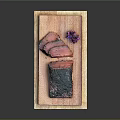 Two Green and Pink Meat Pieces with Purple Flower Garnish Served on Wooden Board