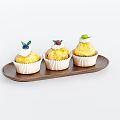Freshly Baked Cupcakes on Wooden Tray Topped with Berries and Green Leaves