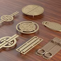 Golden Door Handles with Various Intricate Designs Placed on Wooden Surface