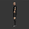 Man in Black Referee Uniform with Short Sleeves Shorts and Chest Badge