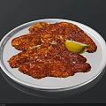 Spicy Seasoned Meat Slices Served On White Plate With Lemon Wedge