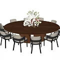 Elegant Modern Private Dining Room With Round Wooden Table Chairs And Flower Arrangement