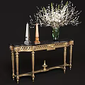 Elegant Gold Carved Console Table With Black Marble Top Green Vase And White Floral Arrangement