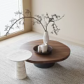 Round Wooden Coffee Table With White Vase Black Twigs And White Marble Side Table