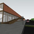 Modern Architectural Building With Red Brick Facade Glass Windows Sloped Roof And Open Plaza