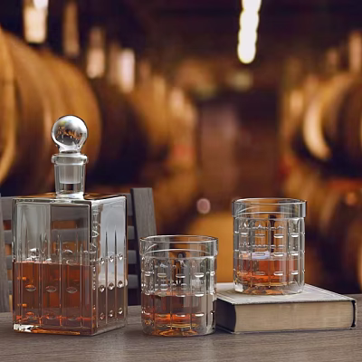 Elegant Whiskey Bottle and Crystal Glasses with Amber Liquid on Wooden Table and Oak Barrels 3d model