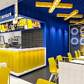 Bole Burger Restaurant Vibrant Yellow Blue Decor Open Dining Area With Counter Chairs Pendant Lights